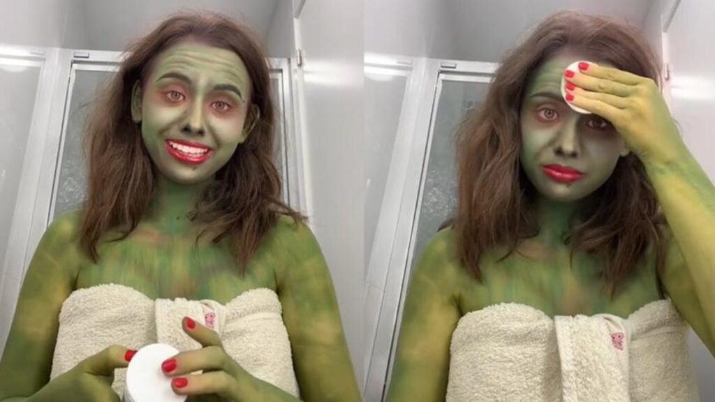 Ragazza dipinge il corpo di verde per Halloween